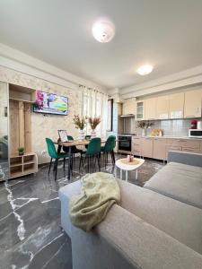 a living room with a couch and a table with chairs at Studios Palas by GLAM Center Area and Mall - Parking Option in Iaşi