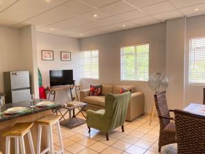 a living room with a couch and a table at Granaat Pit - Paarl - Self Catering Apartment in Paarl