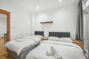 a group of four beds in a room at Studio 169 in London