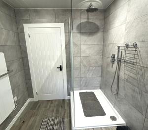 ein Badezimmer mit Dusche mit Glastür in der Unterkunft Smiddy Cottage in Portmahomack + 13 Fotos