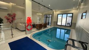 a large swimming pool in a house at شاليهات إطلالة البحر in Al Khobar