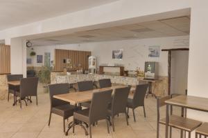 een eetkamer met houten tafels en stoelen bij Hotel des Etrangers in Bonifacio