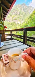 a person holding a cup of coffee on a table at ALLA CASCATA in centro Branzi self check-in parcheggio gratuito coperto in Branzi +27 photos