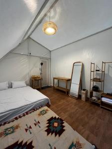 a bedroom with a bed and a desk in a tent at D'River Luxcamp  +17 photos