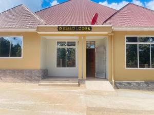 a building with a sign on the front of it at Emao Lodge 