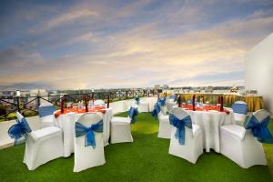 a group of tables and chairs with blue bows at Regency Kanchipuram by GRT Hotels in Kanchipuram