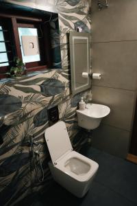 a bathroom with a toilet and a sink at Coastline 4Bedroom cliffside villa in Elattūr