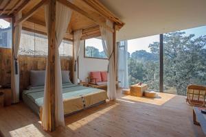 a bedroom with a bed and a large window at Shan Jue Xing She in Nan'an