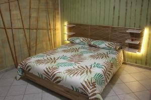 a bedroom with a bed with a comforter on it at Alba Camere Chiomonte in Chiomonte