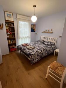 a bedroom with a bed and a book shelf at Comfort & quiet with garden in Saint-herblain in Saint-Herblain