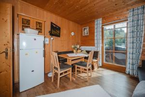 a kitchen and dining room with a table and a refrigerator at Kleintierhof Seidl-Eder in Rauris +56 photos