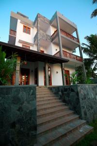 a house with stairs leading up to it at Peak House in Hiriketiya