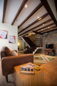 a living room with a couch and a table at Casa dos Livros - Guest House in Vila Nova de Tazem