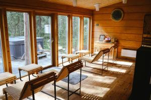 a group of chairs sitting in a room with windows at Treehotel in Harads