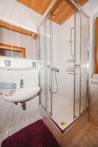 a bathroom with a sink and a shower at Kleintierhof Seidl-Eder in Rauris