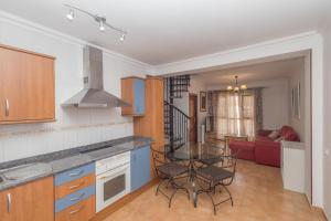 a kitchen with a table and chairs in a room at 3BR Buddha Penthouse - Solarium & Pool in Sardina