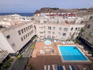 an overhead view of a building with a swimming pool at 3BR Buddha Penthouse - Solarium & Pool in Sardina