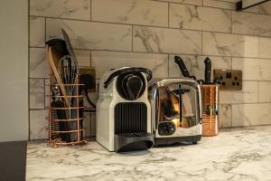 a kitchen counter with a toaster and other kitchen utensils at The Old Loft House in Chew Stoke in Chew Stoke +12 photos