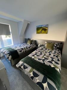 Ένα ή περισσότερα κρεβάτια σε δωμάτιο στο Porters Lodge