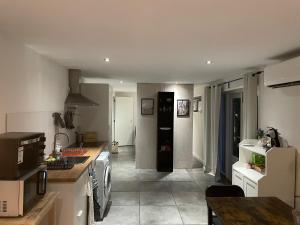 a kitchen with white cabinets and a counter top at Gastensuite Eindhoven B&B Flora in Eindhoven