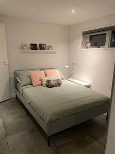 a bed with two pillows on it in a bedroom at Gastensuite Eindhoven B&B Flora in Eindhoven