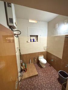a bathroom with a toilet and a sink at Lenzo Home Stays in Kāsaragod