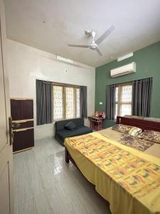 a bedroom with a large bed and green walls at Lenzo Home Stays in Kāsaragod