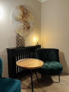 a room with a table and a chair and a globe at Hotel Garni BALTICpetite in Heringsdorf