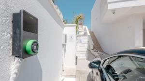 a car is parked next to a wall with a green sensor at Diva Luxury Suite in Torre San Giovanni Ugento