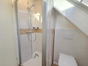 a bathroom with a shower and a toilet in a room at Appartement Turmblick in Marienhafe +21 photos