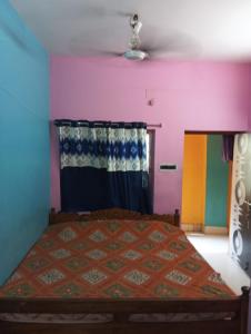 a bedroom with a bed with colorful walls at Sarat guest house in Digha