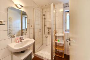 a bathroom with a sink and a shower at Ferienwohnung Merkel in Koserow +23 photos