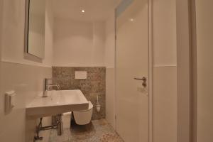 a bathroom with a sink and a toilet and a shower at Appartement Residence Sudersee in Holle Poarte +19 photos