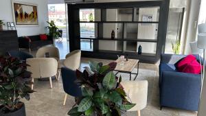 a living room with a blue couch and chairs at Hotel Xon's Valencia in Aldaya