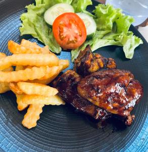 a plate of food with chicken wings and french fries at Hillside bali in Kubupenlokan +31 photos