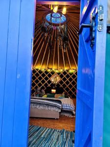 a room with a bed inside of a yurt at A Magical Cosy Garden Yurt in Ladyʼs Odell