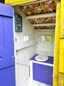 a toilet sitting inside of a play house at A Magical Cosy Garden Yurt in Ladyʼs Odell