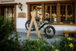 a bike is parked in front of a building at Adler Adelboden in Adelboden