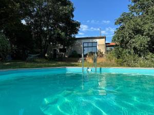a swimming pool in front of a house at Gîte du Séquoia - Paisible maison de campagne in Vallet