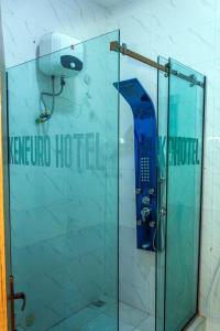 a shower with a glass door in a bathroom at Keneuro hotel & suites in Lagos