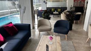 a living room with a couch and chairs and a table at Hotel Xon's Valencia in Aldaya