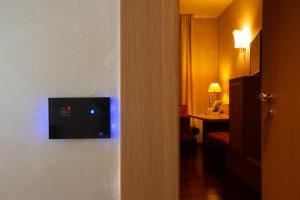 a hotel room with a television on a wall at Poli Hotel in San Vittore Olona