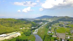 an aerial view of a river with mountains in the background at 名西旅館花 in Tokushima