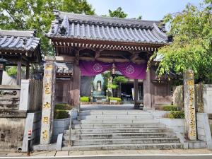 an entrance to a temple with a fountain at 名西旅館花 in Tokushima