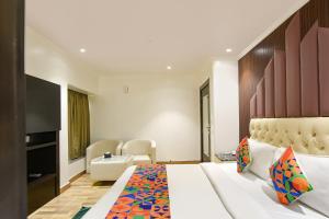 Ένα ή περισσότερα κρεβάτια σε δωμάτιο στο FabHotel Elvilla