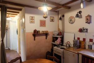 a kitchen with a stove and a table in it at Gite - Le befoigneu in Ramonchamp