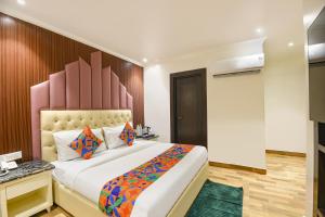 Ένα ή περισσότερα κρεβάτια σε δωμάτιο στο FabHotel Elvilla