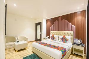 Ένα ή περισσότερα κρεβάτια σε δωμάτιο στο FabHotel Elvilla