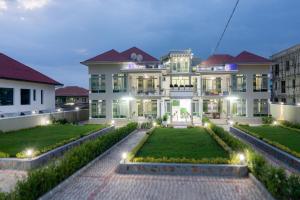 a large house with a garden in front of it at The city Block Apartment in Bujumbura