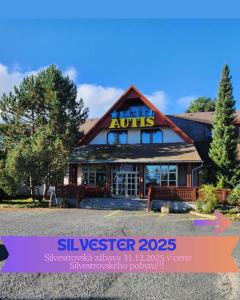 a building with a sign on the front of it at Hotel Autis in Vysoké Tatry